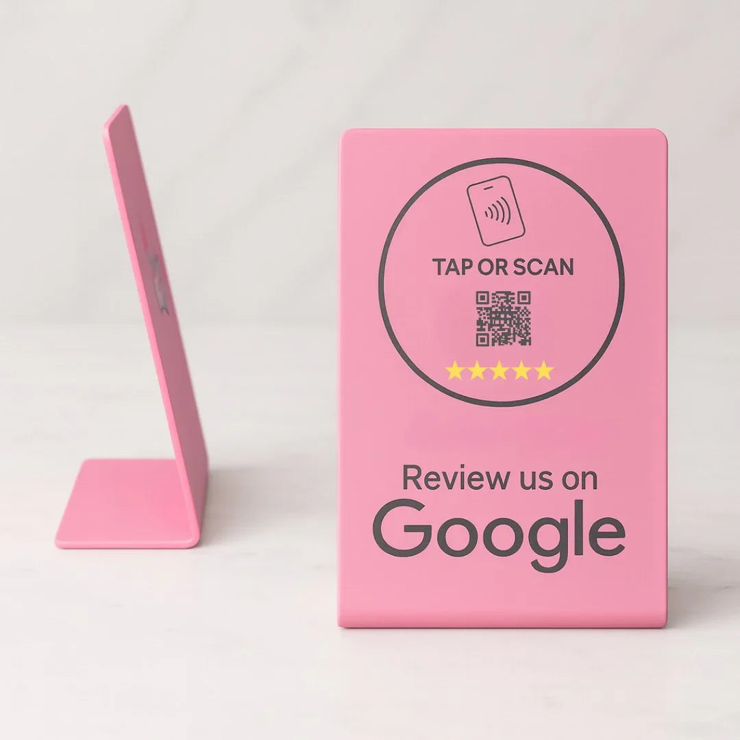Pink sign with QR code and text on a white background