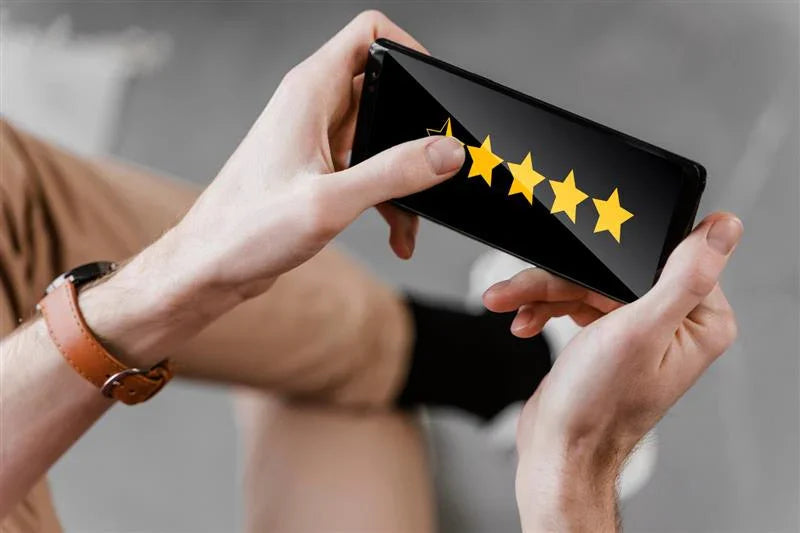 Person giving a five-star rating on smartphone screen, customer feedback concept