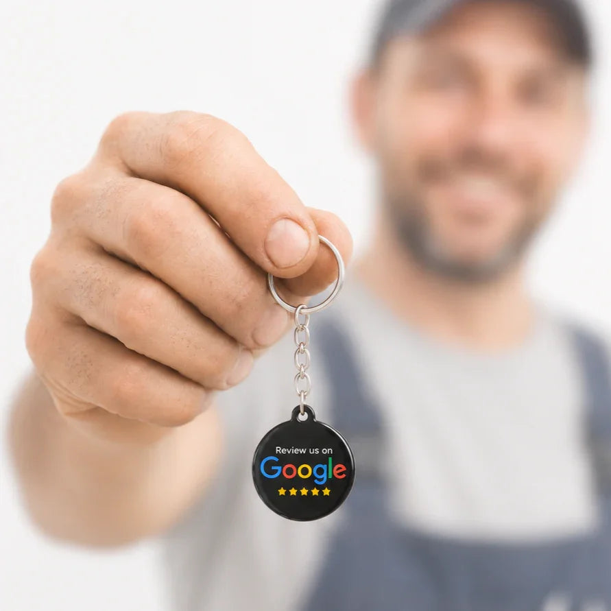TAPro NFC keychains for Google reviews held by contractor in work uniform, realistic ecommerce product image for business reputation growth and customer trust