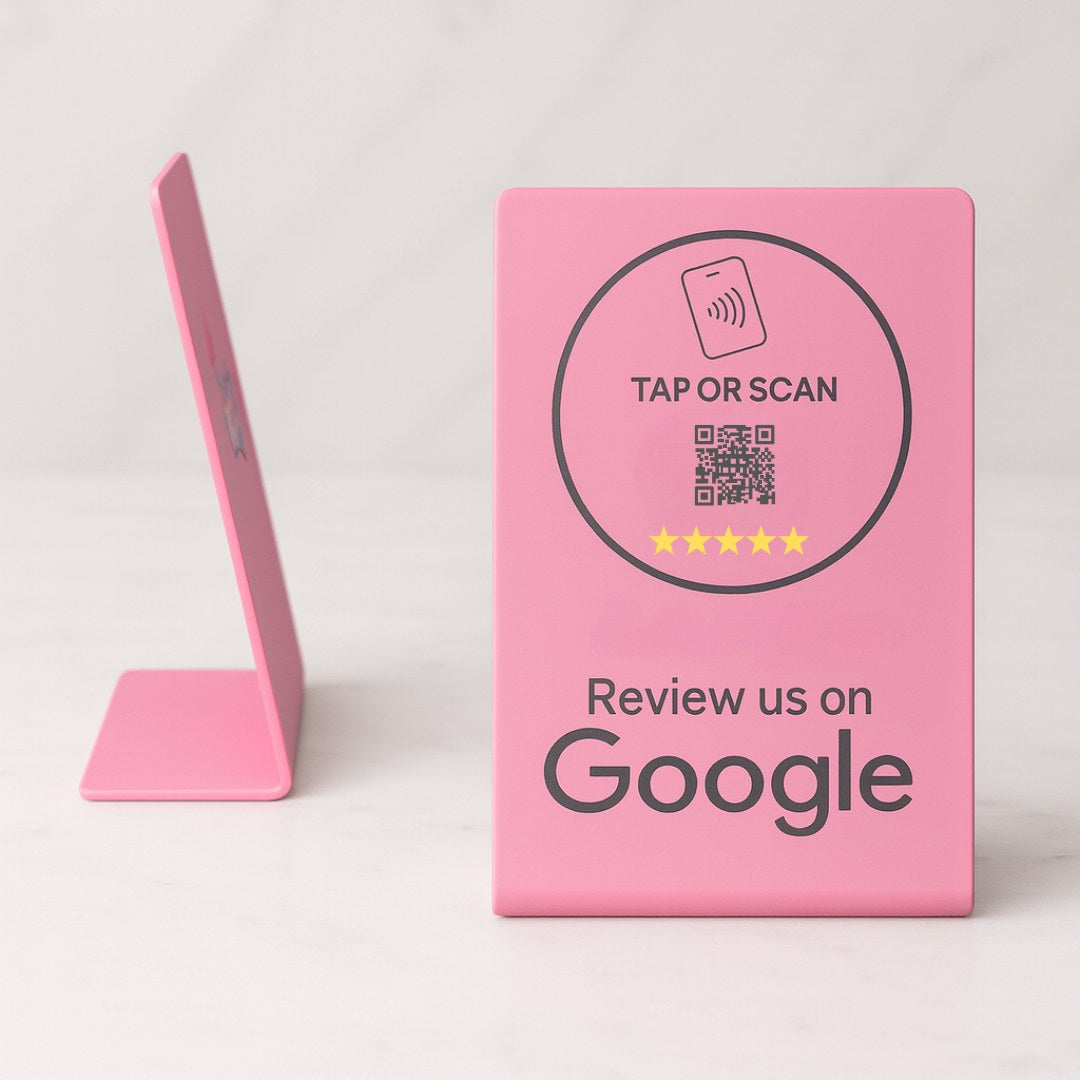 Pink sign with QR code and text on a white background